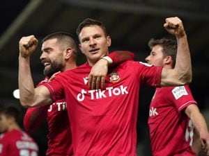 Wrexham's Paul Mullin celebrates scoring their side's third goal of the game during the Emirates FA Cup fourth round match at The Racecourse Ground
