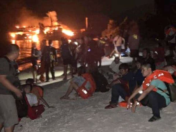 In this photo provided by the Philippine Coast Guard, survivors rest after being rescued from the still burning MV Lady Mary Joy at Basilan, southern Philippines early Thursday March 30