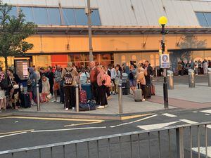 Queues of people waiting outside the Jet2 terminal at Birmingham Airport