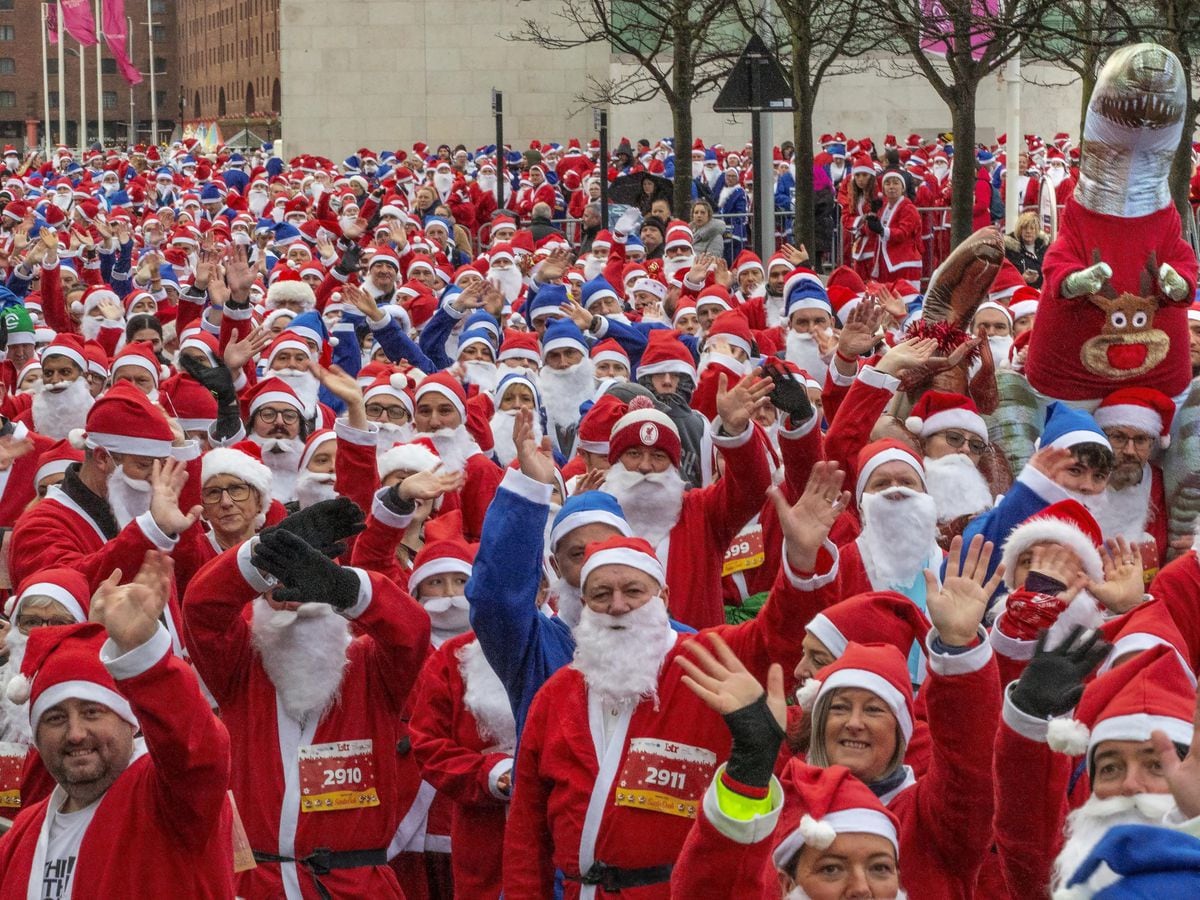 Participants taking part in the Liverpool Santa Dash in Liverpool in aid of Alder Hey Children’s Hospital (Jason Roberts/PA)