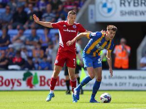 Tom Flanagan of Shrewsbury Town and Shaun Whalley of Accrington Stanley.