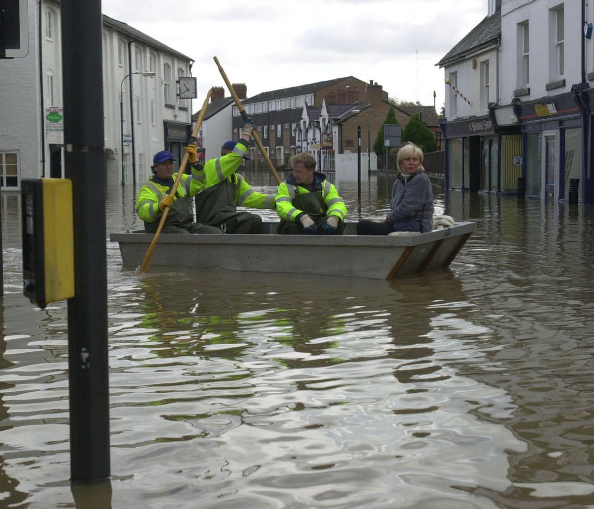 Hairdresser Karen Bradbury uses the council's emergency boat to check on her hair salon in Longden Coleham in the 2000 floods.