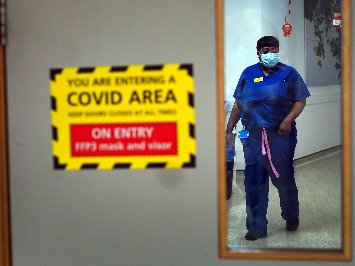 A nurse walks through a Covid ward