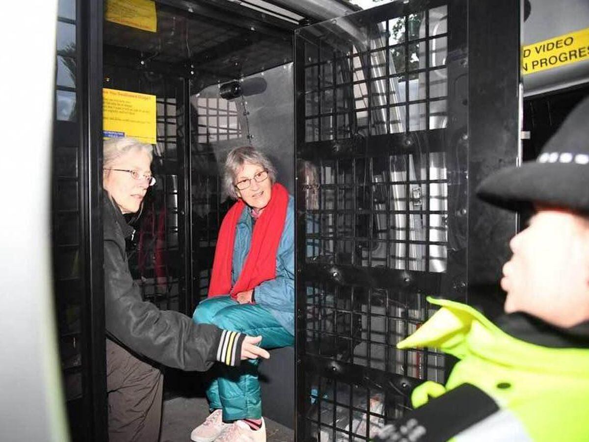 Jo Blackman (left) and another protestor in the back of the police van.