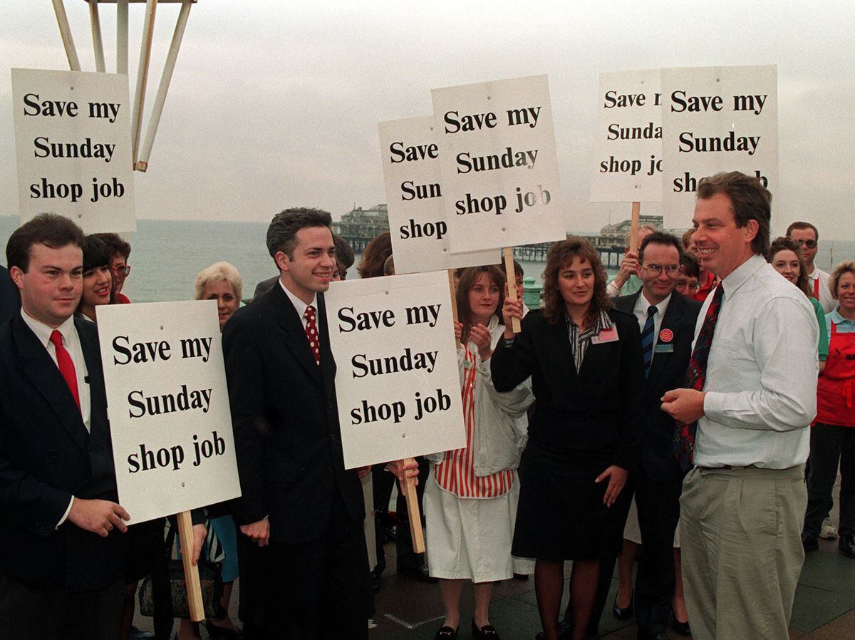 Tony Blair (right) talking to protestors who are demonstrating for the continuation of Sunday Trading outside the Brighton Conference Hall
