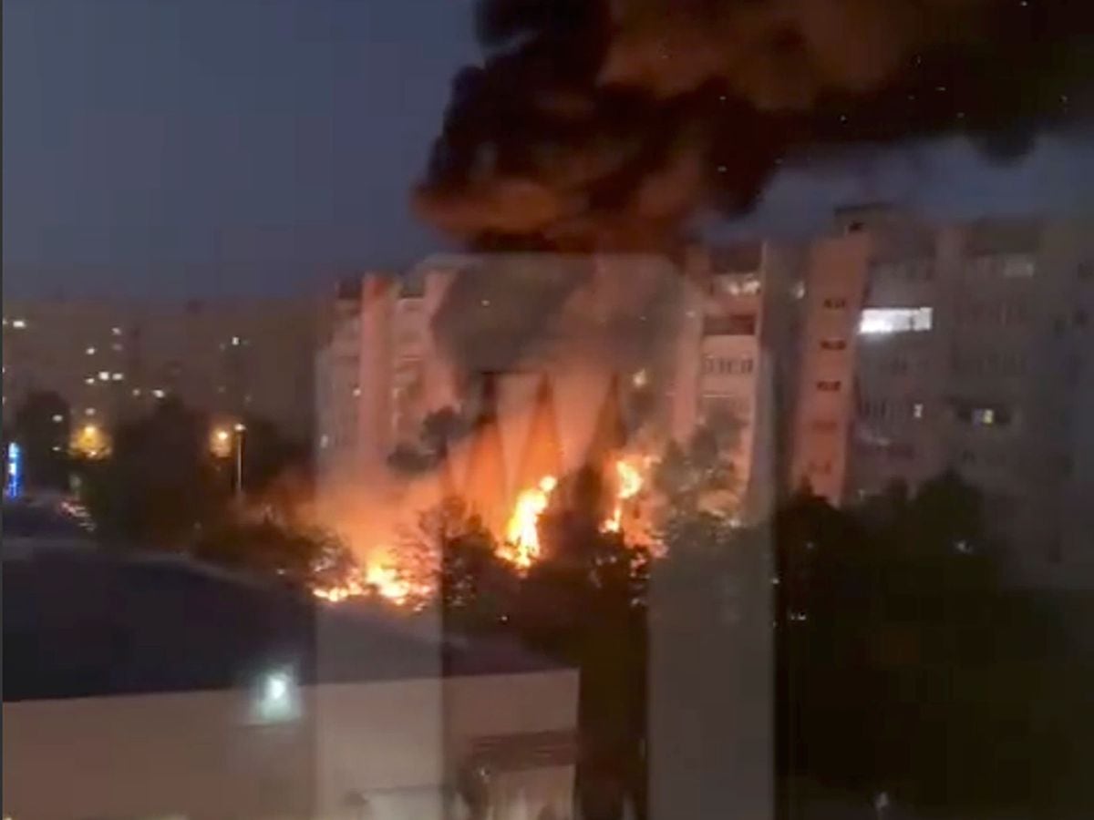 Flames and smoke engulf a building after a warplane crashed in a residential area in Yeysk, Russia