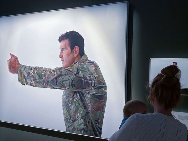 A visitor looks at a display featuring decorated war veteran Ben Roberts-Smith at the Australian War Memorial in Canberra, Australia