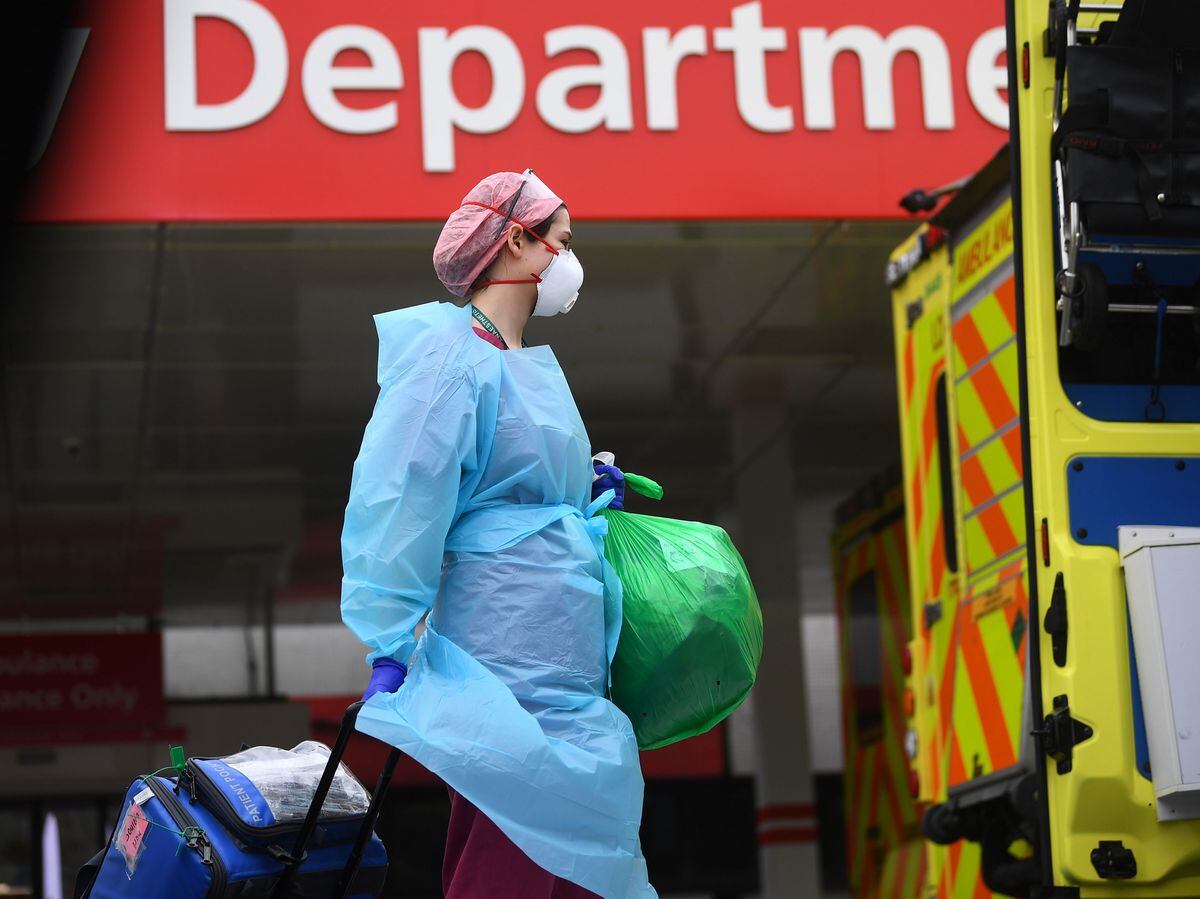 A member of hospital staff wearing personal protective equipment (PPE) outside St Thomas' Hospital in Westminster, London as the UK continues in lockdown to help curb the spread of the coronavirus. PA Photo. Picture date: Monday March 30, 2020. A total of 1,228 patients are reported to have died after testing positive for coronavirus in the UK. See PA story HEALTH Coronavirus. Photo credit should read: Victoria Jones/PA Wire.