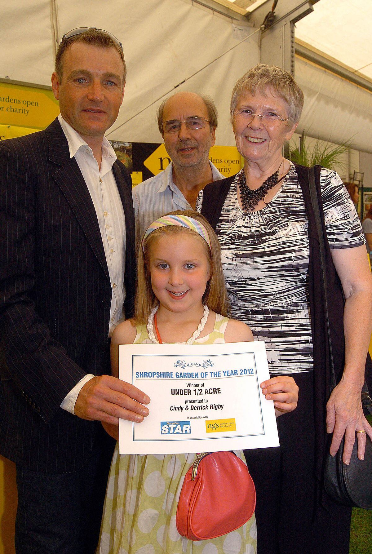 Celebrity gardener Chris Beardshaw presents the Best Garden Under Half An Acre award to Derrick and Cindy Rigby and their granddaughter six-year-old Alex Megan-Higgs at Shrewsbury Flower Show. They were also the overall winners.  