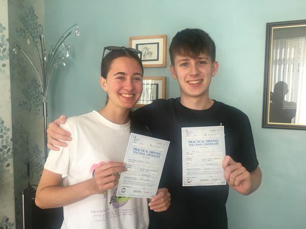 Twins Emma and Alfie Willis holding driving test certificates
