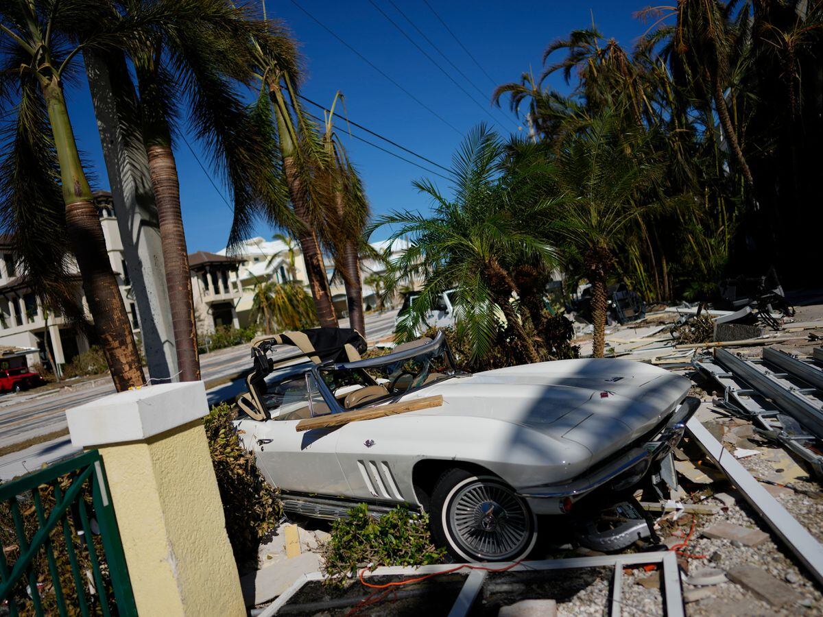 A classic sports car sits where it landed after Hurricane Ian