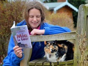 Susie Phillips reading to Jinxie, who is 14