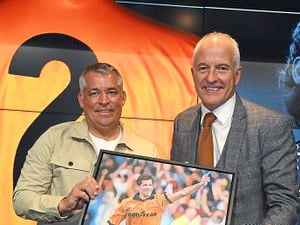 Andy Thompson receives his portrait from friend and fellow Wolves great Steve Bull. Picture courtesy Jim Mayer/Ginger Snaps Photography