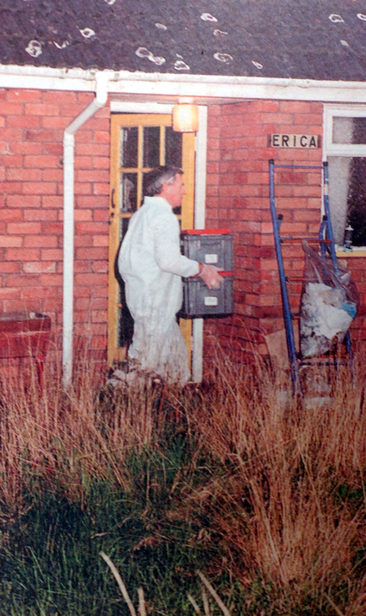 A scenes of crime officer takes away items from Mr Coles home after h is death in 1994