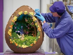 Chocolatier Dawn Jenks adds the finishing touches to the Easter-themed chocolate creation at Cadbury World