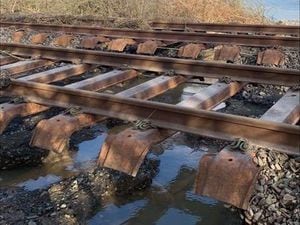 Earth below the railway line near Welshpool has been washed away by the flood. Photo: @NetworkRailWAL
