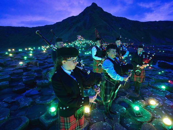 Lumenators create a large-scale art work at the Giant's Causeway as part of Unboxed (Brian Morrison/PA)