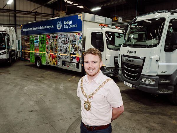 Lord Mayor of Belfast Councillor Ryan Murphy at the Duncrue Complex alongside council HGVs running on hydrotreated vegetable oil