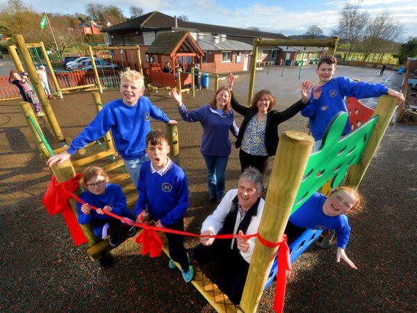 SHREW COPYRIGHT SHROPSHIRE STAR STEVE LEATH 17/03/2023..Pics in Ruyton X1 Towns, at St John the Baptist School, where the community have come together to purchase a new play area. Cutting the ribbon is pupil: Andreas Davis 11, Keith Lister (Chair of the school Govenors), and behind him is Carol Aspinall from the Friends group and Head: Julie Ball. Pupils L-R: Amber Aspinall 9,  Elliot Incles 11, Arthur Doran 10, Devon Humphreys 9.
