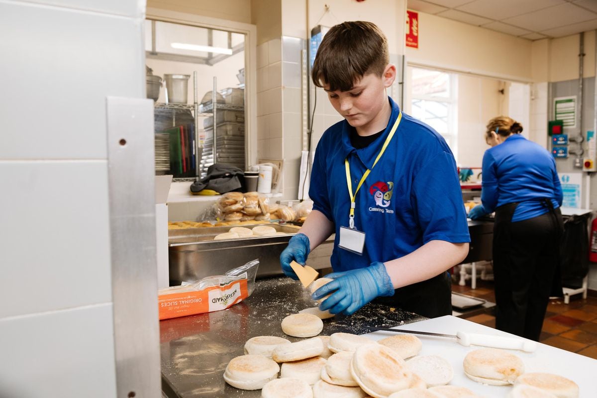 Children at The Burton Borough School in Newport are taking over for the day where teachers and Years 7, 8 and 9 students switch places. In Picture: Ollie Wood 13 preparing the school dinners.