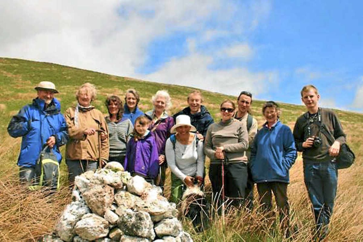 Nephew Rob Green, back row, centre, helps lay a new stone on the Hilda Murrell cairn
