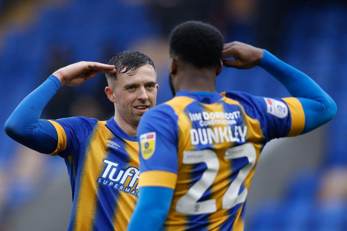 Chey Dunkley of Shrewsbury Town celebrates after scoring a goal to make it 3-1 with Jordan Shipley of Shrewsbury Town (AMA)