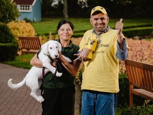 Fundraiser Hakim Rashid is presenting the money he raised to Dogs Trust in Shrewsbury for the sponsored walk that he completed at Roseville House, Wem. He is pictured here with Dogs Trust's Mo Flynn and Snowball the dog (who is deaf)