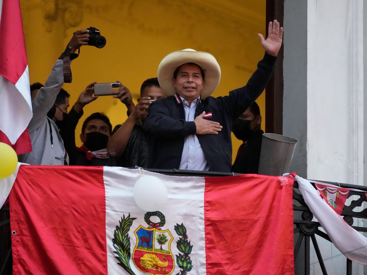 Presidential candidate Pedro Castillo waves to supporters (Martin Mejia/AP)