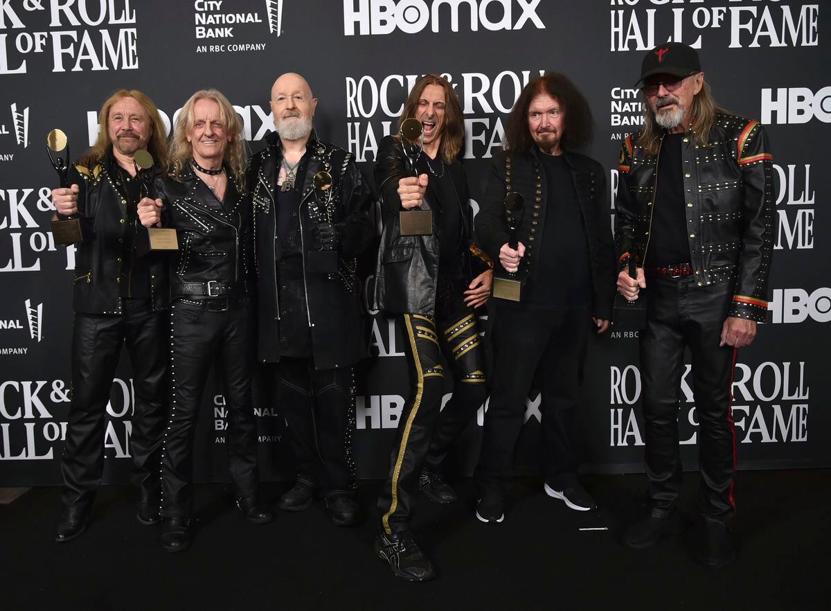 From left, KK Downing, Rob Halford, Scott Travis, Les Binks, and Glenn Tipton of Judas Priest pose in the press room during the Rock & Roll Hall of Fame Induction Ceremony. Photo: Richard Shotwell/Invision/AP.