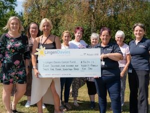 Kerry Clorley (front right holding cheque) from Riello UPS with colleagues and fellow fundraisers from Lingen Davies Cancer Fund with a cheque for the £8434.17 she raised on her family fun day