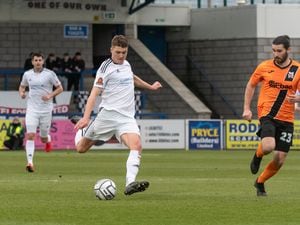 Jordan Piggott (22) (AFC Telford United Defender on loan from Solihull Moores) firing a shot at Darlington goal from just outside the box.