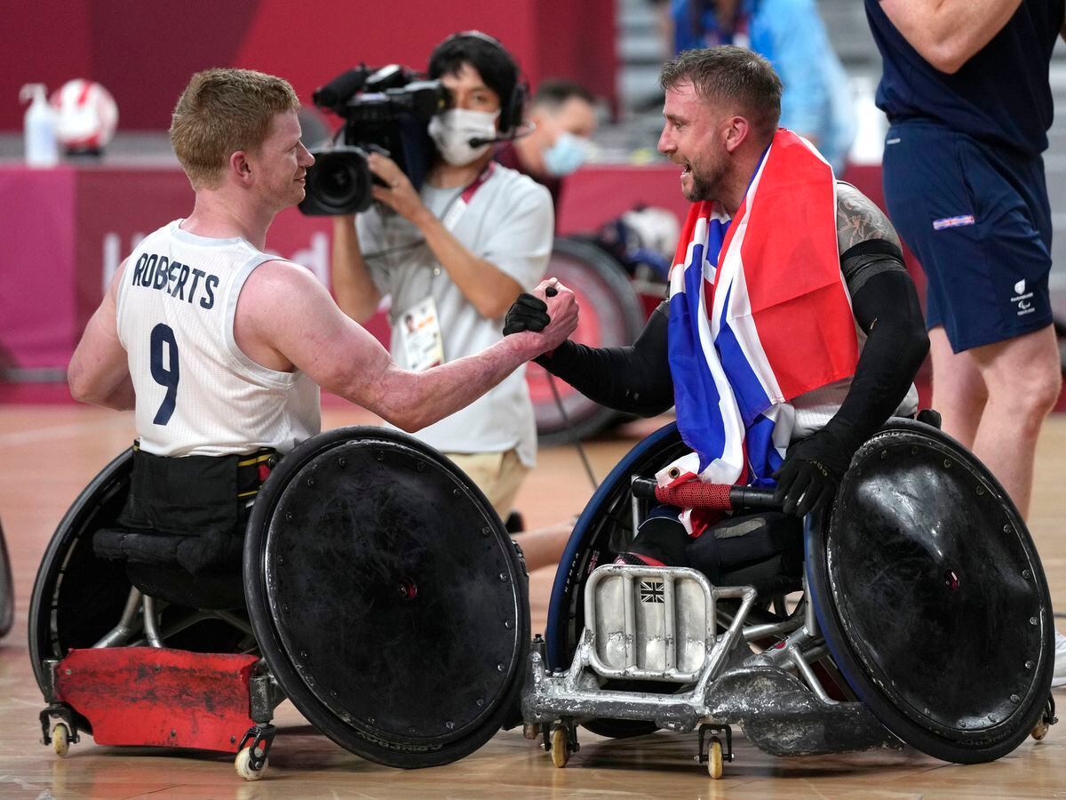 Welshpool's Jim Roberts, left, and Stuart Robinson celebrate after winning the wheelchair rugby gold medal match against the U.S., at the Tokyo 2020 Paralympic Games in Tokyo