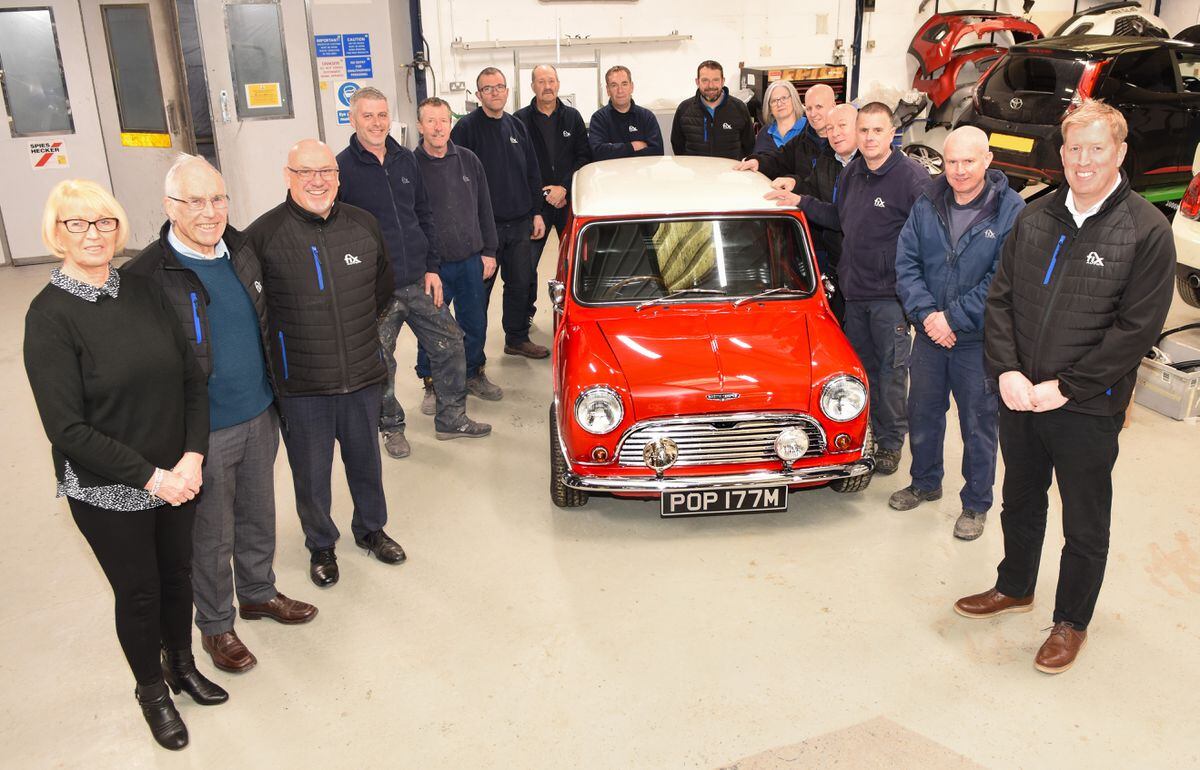 Unrivalled experience… Ann and Robin Hitch (extreme left) and their son Lee (right) with colleagues at Fix Auto Oswestry and Fix Auto Wrexham who’ve clocked up a staggering 450+ years between them.
