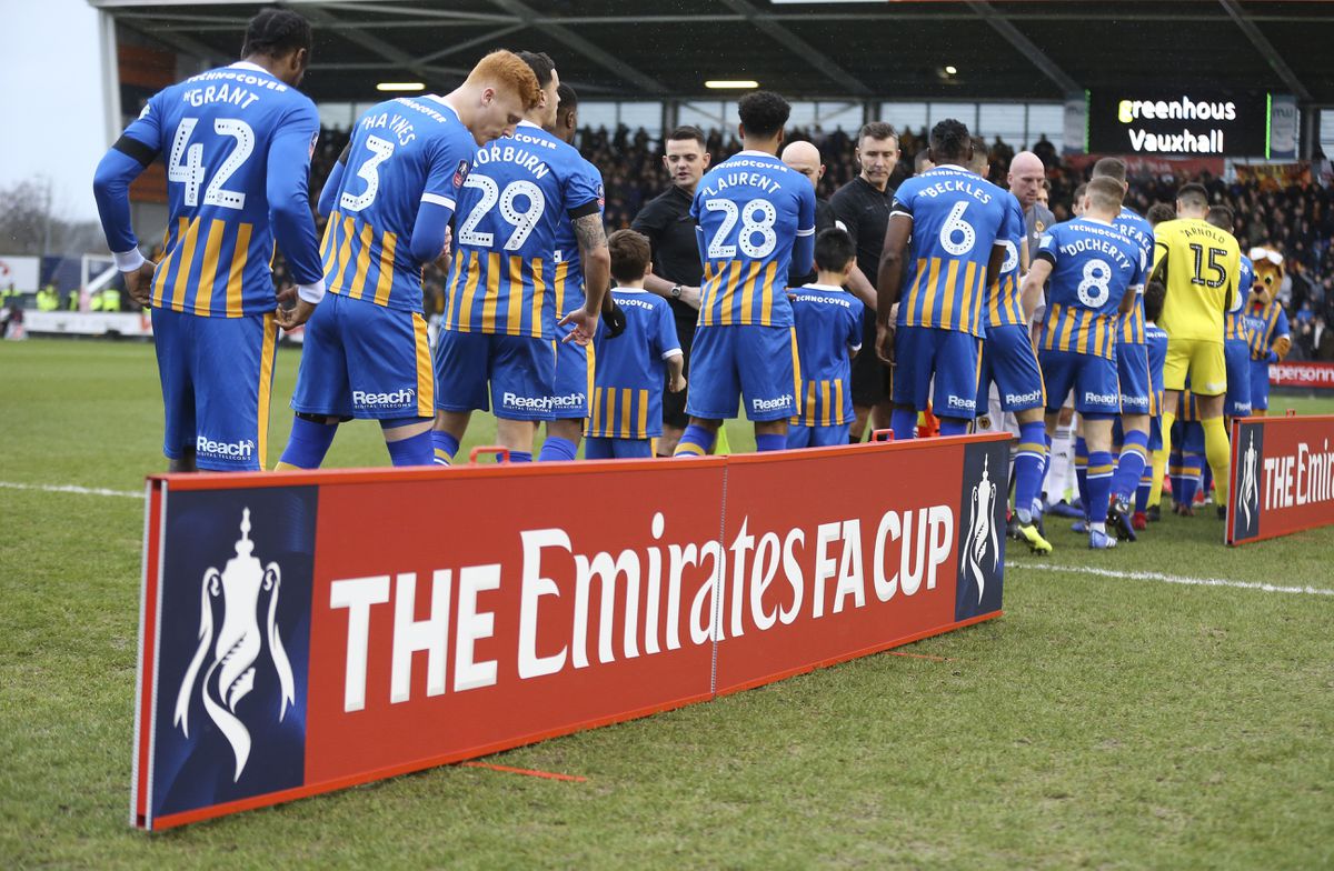 The Emirates FA Cup branding as Shrewsbury Town and Wolverhampton Wanderers shake hands before kick off. (AMA)