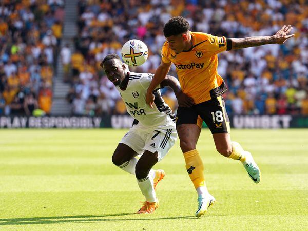 Wolverhampton Wanderers' Morgan Gibbs-White (right) and Fulham's Neeskens Kebano during the Premier League match at the Molineux Stadium, Wolverhampton. Picture date: Saturday August 13, 2022. PA Photo. See PA story SOCCER Wolves. Photo credit should read: David Davies/PA Wire.