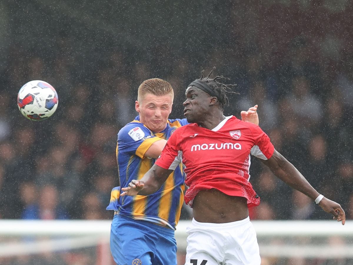 Taylor Moore of Shrewsbury Town and Arthur Gnahoua of Morecambe.