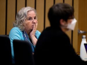 Romance writer Nancy Crampton Brophy, left, watches proceedings in court