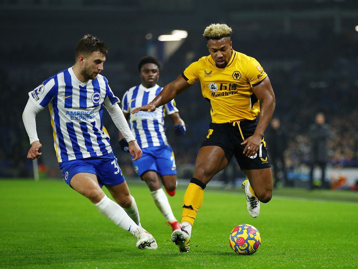 Adama Traore of Wolverhampton Wanderers battles for possession with Joel Veltman of Brighton & Hove Albion during the Premier League match between Brighton & Hove Albion and Wolverhampton Wanderers at American Express Community Stadium on December 15, 2021 in Brighton, England. (Photo by Wolverhampton Wanderers FC/Wolves via Getty Images).