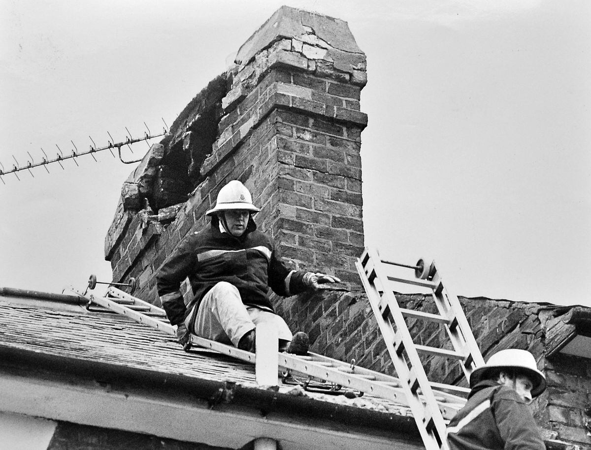Firefighters making safe a damaged chimney in Shrewsbury in 1990