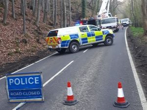 Police closed the A488 on Tuesday after a landslide and trees came down on the road
