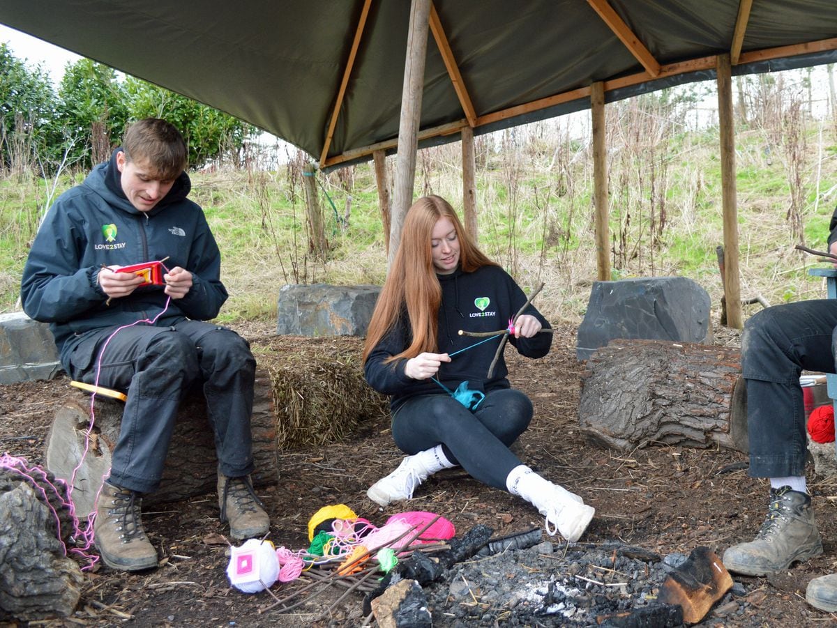 Love2Stay activities manager Cassie Miles with instructors Oli Wilde and Will Chatting practicing their bushcraft and Saplings Woodland School skills