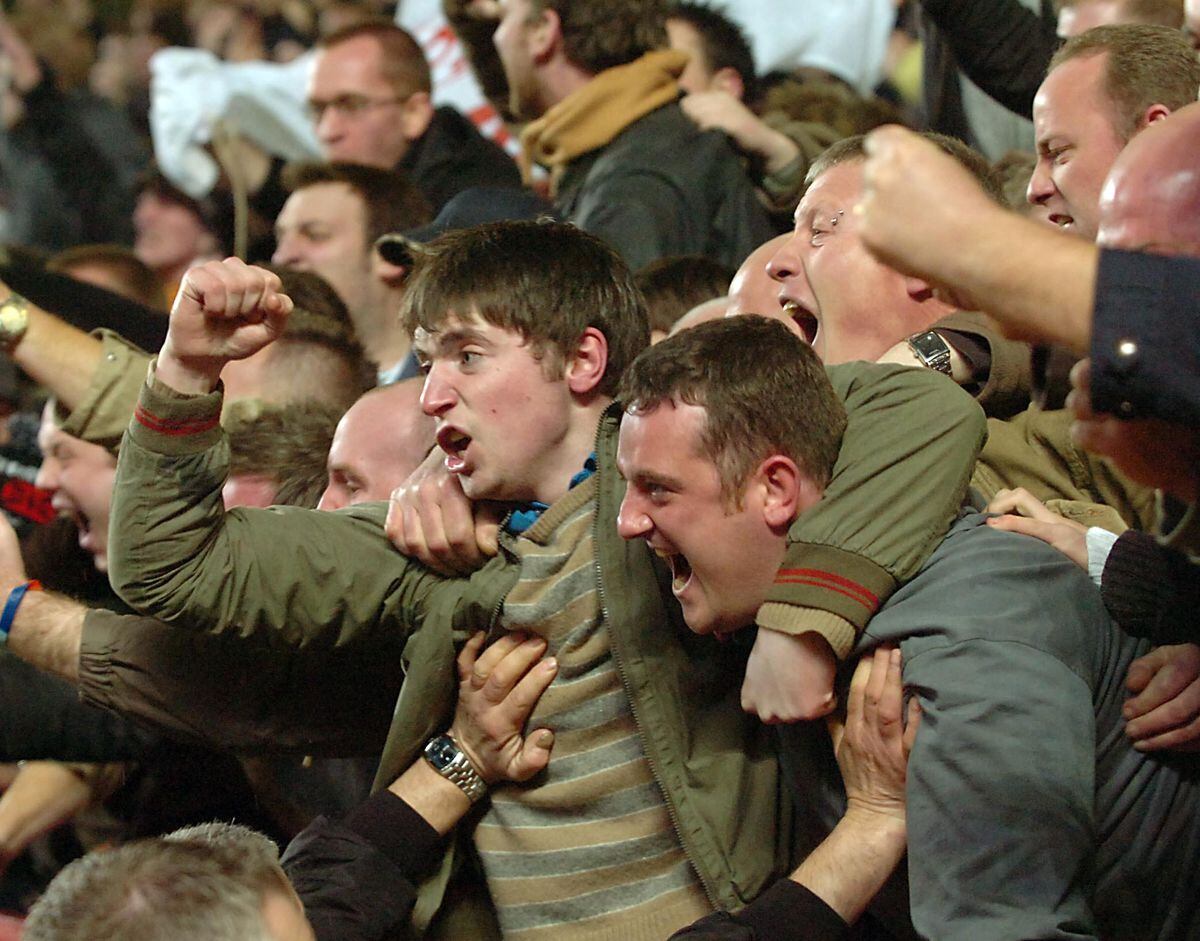 Wolves fans show their delight after Karl Henry scores his winner.