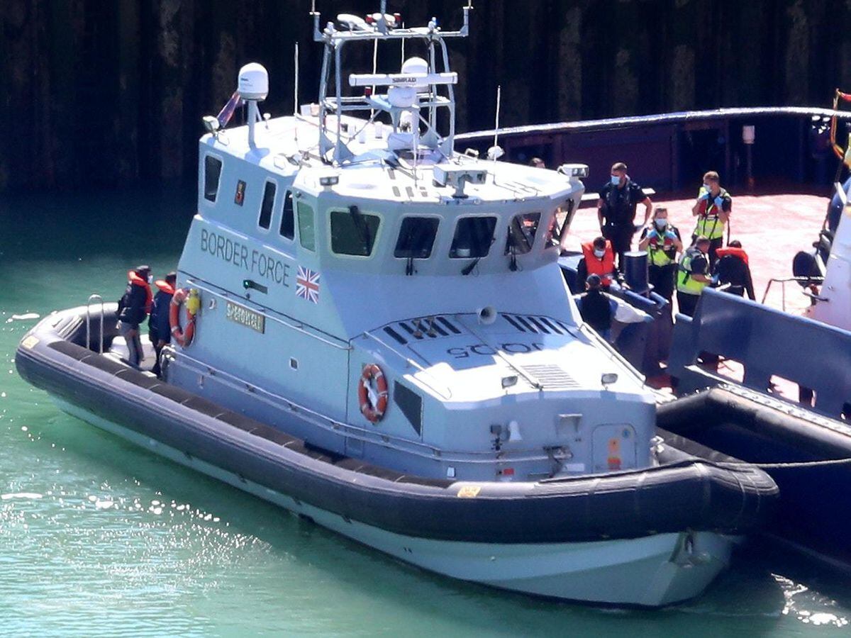 A group of people thought to be migrants are brought into Dover
