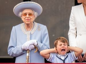 Queen Elizabeth II and Prince Louis on the balcony of Buckingham Palace