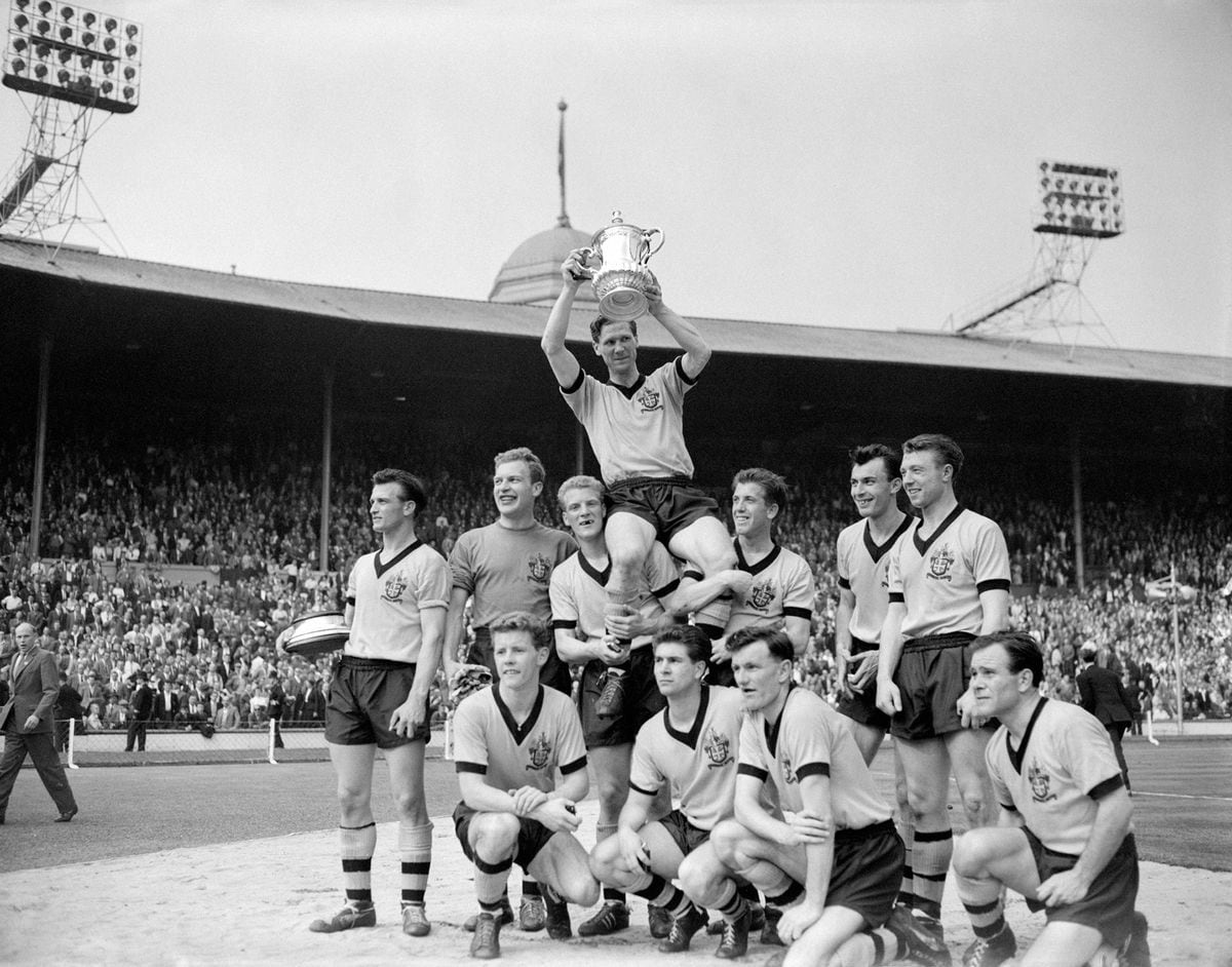 Wolverhampton Wanderers captain Bill Slater holds the FA Cup aloft as he is chaired by his jubilant teammates: (back row, l-r) Gerry Harris, Malcolm Finlayson, Ron Flowers, Peter Broadbent, Eddie Clamp, George Showell; (front row, l-r) Barry Stobart, Des Horne, Jimmy Murray, Norman Deeley.