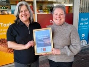 Julie Edwards, left, general manager at Mere Motors, receives a business fundraising certificate from Ellesmere’s Poppy Appeal organiser Lynn Howard