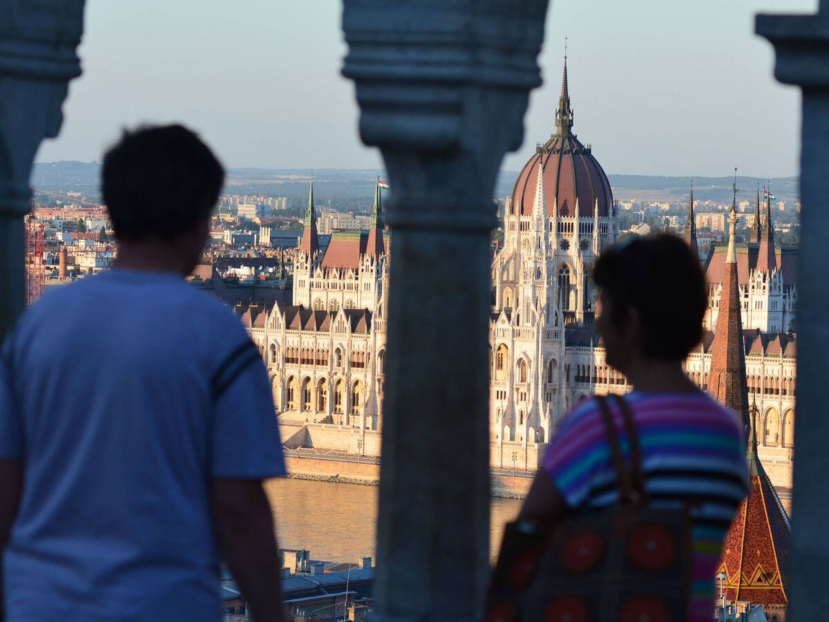 Tourists viewing Budapest's parliament building