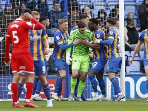 Marko Marosi of Shrewsbury Town is congratulated by his team mates after making a save (AMA)