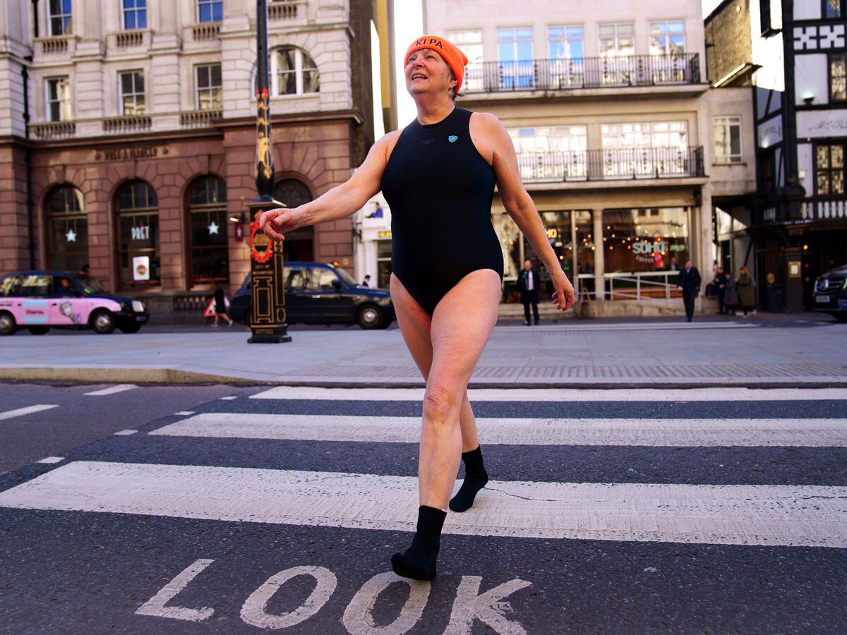 A swimmer from Hampstead Ponds crosses the road outside the Royal Courts of Justice, London