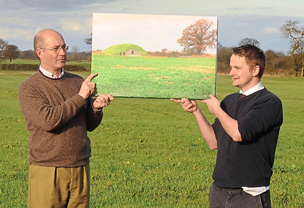 Holding an artist’s impression of the long barrow are, left, Sacred Stones MD Toby Angel and Tim Ashton, who owns the land